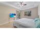 Bedroom featuring a tray ceiling with fan, carpet, and sliding door for natural lighting at 130 Bella Vista Ter # 10A, Nokomis, FL 34275