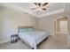 Bedroom features a tray ceiling with fan and window overlooking lush outdoor landscaping at 130 Bella Vista Ter # 10A, Nokomis, FL 34275