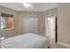 Cozy bedroom with neutral walls, plush carpet, a ceiling fan, a window, and a double door closet at 130 Bella Vista Ter # 10A, Nokomis, FL 34275