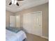 Spacious bedroom featuring neutral walls, plush carpet, a ceiling fan, a closet, and a window at 130 Bella Vista Ter # 10A, Nokomis, FL 34275