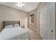 Bedroom with large closet and window for natural lighting features neutral tones at 130 Bella Vista Ter # 10A, Nokomis, FL 34275