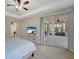 Bedroom features tray ceilings, carpet, and sliding door providing access to the screened patio at 130 Bella Vista Ter # 10A, Nokomis, FL 34275