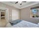 Inviting bedroom with tray ceiling, ceiling fan, window, closet, and plush carpet at 130 Bella Vista Ter # 10A, Nokomis, FL 34275