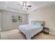 Neutral bedroom features a tray ceiling with fan and window overlooking lush outdoor landscaping at 130 Bella Vista Ter # 10A, Nokomis, FL 34275