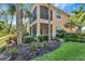 Charming home with a screened-in porch, surrounded by lush landscaping and mature trees at 130 Bella Vista Ter # 10A, Nokomis, FL 34275