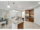 Bright, open kitchen with a large island and views into the adjacent living spaces at 130 Bella Vista Ter # 10A, Nokomis, FL 34275