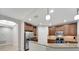 Open-concept kitchen showcasing sleek stainless steel appliances and stylish cabinetry at 130 Bella Vista Ter # 10A, Nokomis, FL 34275