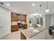 Modern kitchen featuring granite countertops, stainless steel appliances, and ample cabinet space at 130 Bella Vista Ter # 10A, Nokomis, FL 34275