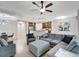 Open concept living room features ceiling fan, tile floors, and views of kitchen at 130 Bella Vista Ter # 10A, Nokomis, FL 34275