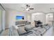 Bright living room boasts tile floors, ceiling fan, and access to dining area for open concept living at 130 Bella Vista Ter # 10A, Nokomis, FL 34275