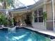Inviting backyard featuring a pool, spa, and covered patio for outdoor enjoyment at 1354 Tearose Pl, Sarasota, FL 34239