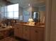 Luxurious bathroom with double vanity, marble floors, and large mirror at 1354 Tearose Pl, Sarasota, FL 34239