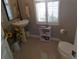 Bathroom featuring pedestal sink, tile floors, and window with plantation shutters at 1354 Tearose Pl, Sarasota, FL 34239