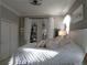 Bright bedroom features white linens and decor with light coming through the French doors at 1354 Tearose Pl, Sarasota, FL 34239