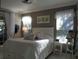 Well lit bedroom with large window, tile floor, and bed with white bedding at 1354 Tearose Pl, Sarasota, FL 34239