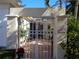 Charming entry gate leads to a private brick-paved courtyard with lush greenery at 1354 Tearose Pl, Sarasota, FL 34239