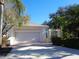 View of the two-car garage on a single-story home with paver driveway at 1354 Tearose Pl, Sarasota, FL 34239