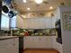 Bright kitchen with white cabinets, mirrored backsplash, and stainless steel appliances at 1354 Tearose Pl, Sarasota, FL 34239