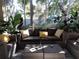 Outdoor lanai with comfortable wicker furniture perfect for enjoying the serene view at 1354 Tearose Pl, Sarasota, FL 34239