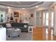Spacious living room featuring hardwood floors, gray walls, and decorative guitars at 1354 Tearose Pl, Sarasota, FL 34239
