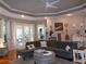 Comfortable living room with hardwood floors, fan, and decorative wall art at 1354 Tearose Pl, Sarasota, FL 34239