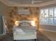 Serene main bedroom featuring a textured wall, plantation shutters and a king size bed at 1354 Tearose Pl, Sarasota, FL 34239