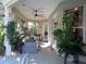 Covered outdoor patio featuring a ceiling fan and a comfortable seating area, perfect for relaxation at 1354 Tearose Pl, Sarasota, FL 34239