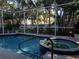 Screened-in pool and spa offers a private oasis surrounded by lush landscaping at 1354 Tearose Pl, Sarasota, FL 34239