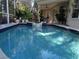 Sparkling blue pool with decorative water feature, perfect for relaxation and entertainment at 1354 Tearose Pl, Sarasota, FL 34239