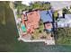 Waterfront property featuring a sparkling pool, dock, lush landscaping and ample parking space for residents and guests at 1444 Ridgewood Ln, Sarasota, FL 34231