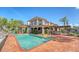 Exterior shot of home featuring a private pool, patio, lush landscaping, and beautiful architectural details at 1444 Ridgewood Ln, Sarasota, FL 34231
