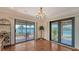 Dining room with stunning waterfront views and easy access to the outdoor patio and pool area at 1444 Ridgewood Ln, Sarasota, FL 34231