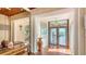Welcoming foyer with tiled floor, decorative mirror, and view to the outside through glass doors at 1444 Ridgewood Ln, Sarasota, FL 34231