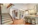 Entryway with staircase leading to a kitchen with stainless steel appliances at 1444 Ridgewood Ln, Sarasota, FL 34231