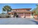 Inviting two-story home with a spacious driveway and lush greenery, perfect for Gathering living at 1444 Ridgewood Ln, Sarasota, FL 34231