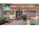 Charming home entrance with a decorative gate, unique architecture, and well-maintained landscaping at 1444 Ridgewood Ln, Sarasota, FL 34231