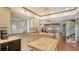 Bright eat-in kitchen boasts tile flooring and updated appliances with a direct view of the living room at 1444 Ridgewood Ln, Sarasota, FL 34231