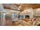 Open-concept living room with fireplace, wood ceiling, and partial kitchen view at 1444 Ridgewood Ln, Sarasota, FL 34231