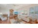 Bright living room with neutral tones, ceiling fan, and open layout at 1444 Ridgewood Ln, Sarasota, FL 34231
