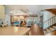 Open-concept living room boasts a fireplace, tile flooring, exposed beam vaulted ceilings and natural light at 1444 Ridgewood Ln, Sarasota, FL 34231