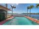 Enjoy this private pool with gorgeous water views and beautifully manicured landscaping at 1444 Ridgewood Ln, Sarasota, FL 34231