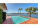 Private pool with brick border offers stunning water views and lush landscaping for a resort-style experience at 1444 Ridgewood Ln, Sarasota, FL 34231