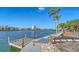 Picturesque waterfront view with a dock and lush tropical landscaping at 1444 Ridgewood Ln, Sarasota, FL 34231