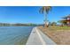 Scenic waterfront view with concrete seawall and lush landscaping at 1444 Ridgewood Ln, Sarasota, FL 34231