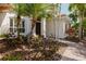 Inviting front entrance with a beautiful pathway through lush landscaping to a dark wood door at 14819 Bowfin Ter, Lakewood Ranch, FL 34202