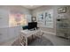 Bright home office featuring built-in cabinets, a desk, and a large window with plantation shutters at 14819 Bowfin Ter, Lakewood Ranch, FL 34202