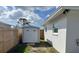 Backyard features a storage shed, partial wood fence, and a well-maintained exterior of a white house at 1715 Thomas Dr, Clearwater, FL 33759