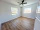 Bedroom with two windows and luxury vinyl plank flooring at 1715 Thomas Dr, Clearwater, FL 33759