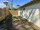 Side yard features new wooden fence providing privacy at 1805 Springwood Dr, Sarasota, FL 34232