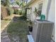 Backyard with newer AC and small potted plants and wooden fence in the background at 1805 Springwood Dr, Sarasota, FL 34232